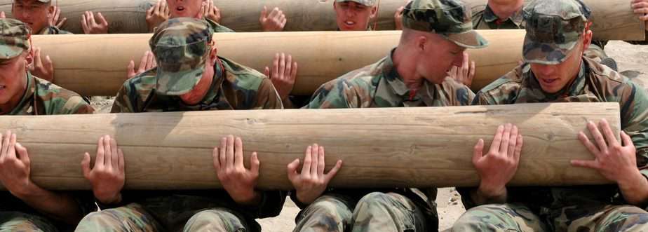 Soldiers carrying a boulder as part of their training.