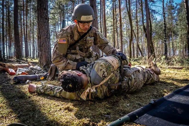 Spc. William Horne, combat medic, assigned to 1st Infantry Division treats and evacuates simulated casualties during U.S. Army Europe Expert Field Medical Badge Combat Testing Lane 3 at Grafenwoehr Training Area,