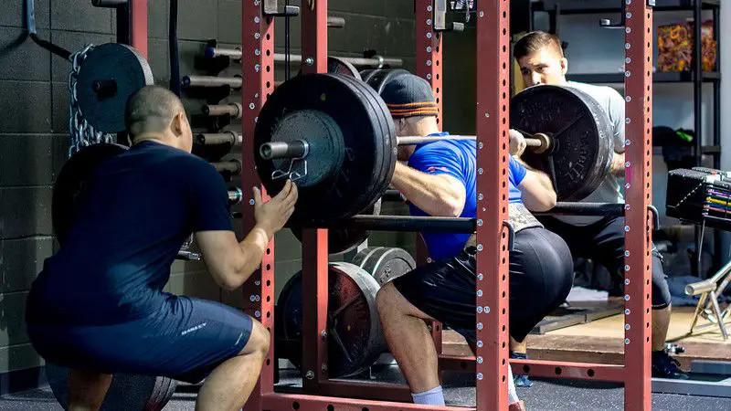 man performing the squat exercise.