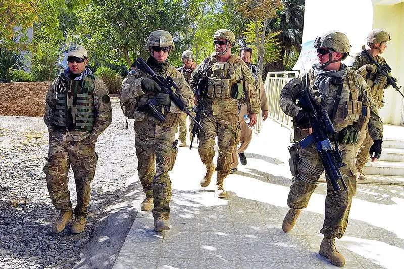 Soldiers walking together in full military gear: what personal items do soldiers carry.