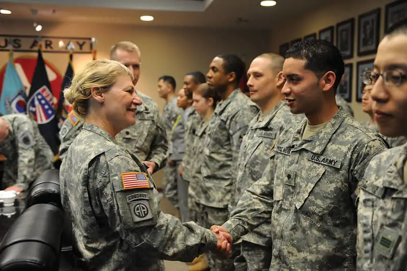 Dunwoody is the first female four-star general in the history of the United States Army shaking hands with soldiers. An example of permitted hair styles in the military
