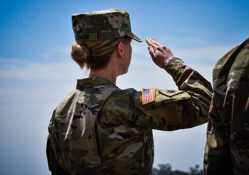 the first woman to take command of a U.S. Army Infantry Division. Her hair is in a bun showcasing an example of acceptable women hair style in the army.
