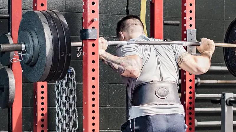 Man doing Squats and not replacing leg day for rucking.